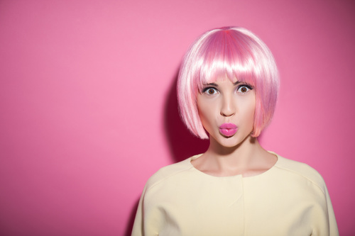 Woman wearing pink wig duck face Stock Photo