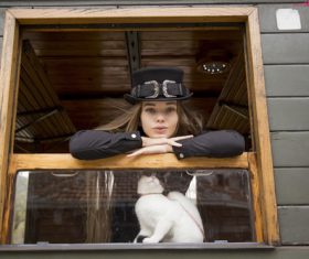 Woman with black top hat and kitten Stock Photo