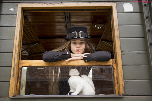 Woman with black top hat and kitten Stock Photo